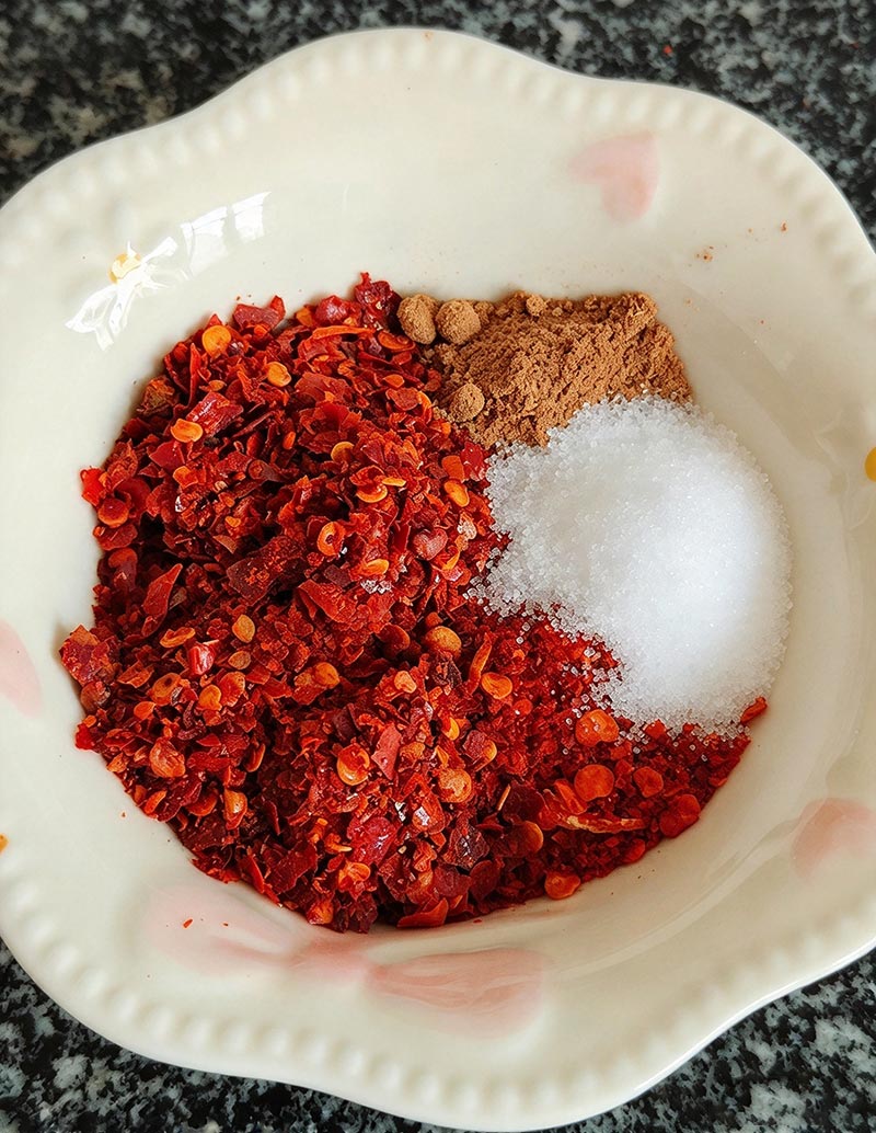 Measuring chili powder, salt, and Thirteen Spice powder for hairy tofu coating