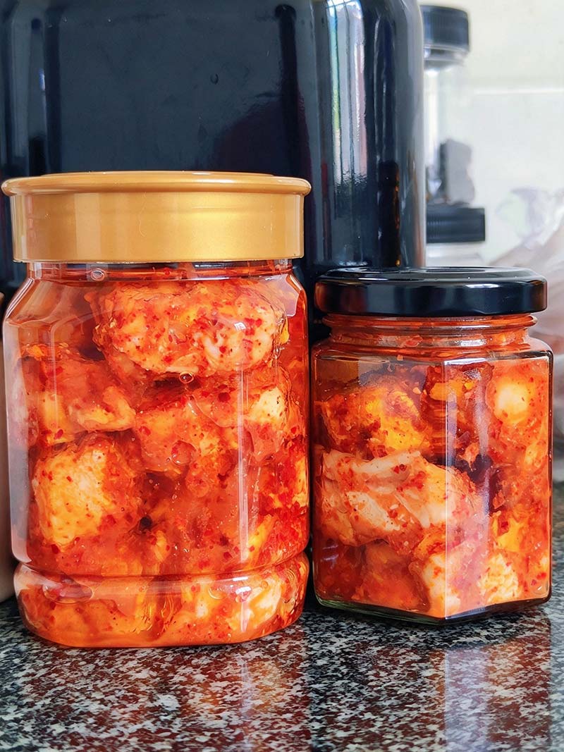 Sealed glass jar of homemade hairy tofu immersed in oil, ready for aging and serving